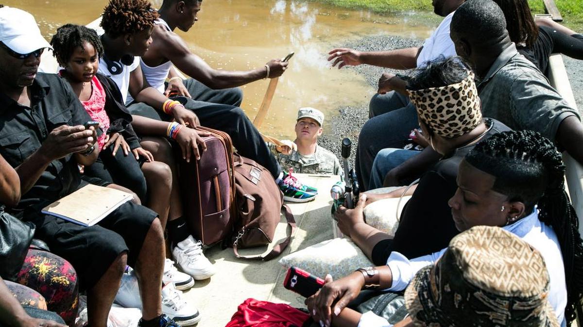 
Sgt. William Buffkin of the South Carolina National Guard helps a family evacuate from Georgetown on Friday.  
