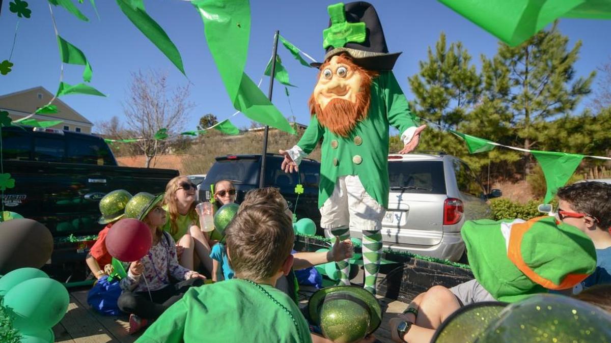 Lucky the Leprechuan (Frank Simino of Fort Mill) greets members of the Baxter Barracudas swim club at a previous Baxter St. Patrick's Day parade. This year parade has been moved to Sunday.
