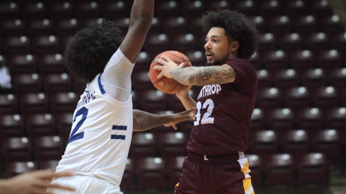 Winthrop’s Josh Corbin looks for an opening around Asheville’s L.J. Thorpe Friday at the Winthrop Coliseum.