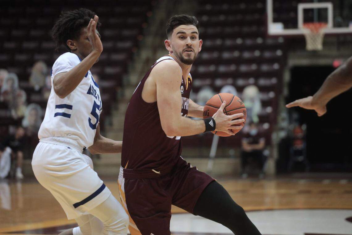 Winthrop’s Chandler Vaudrin heads to the basket around Asheville’s Trent Stephney Friday at the Winthrop Coliseum
