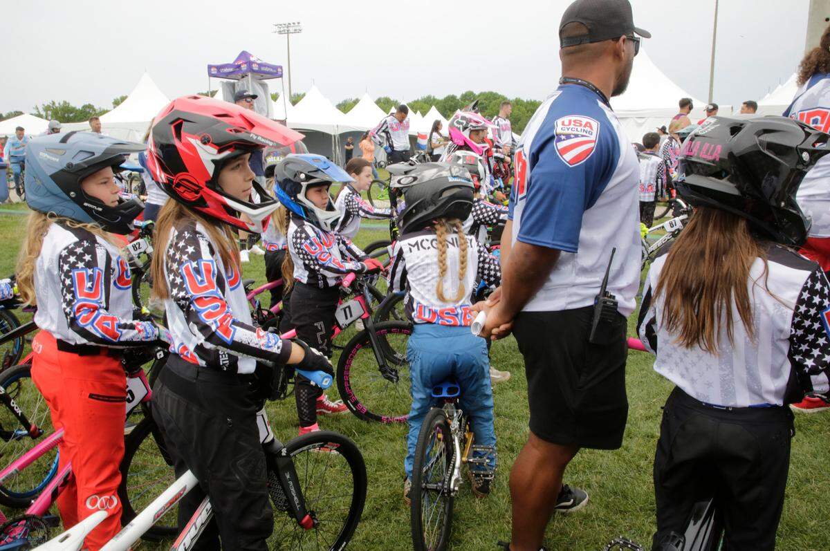 8-year-old Irelyn McGinley, center, pushes her way through a crowd of athletes Monday at the BMX World Championships in Rock Hill.