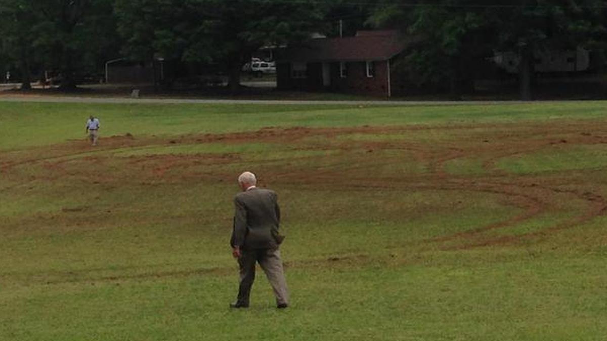 
Church members Gene Gardner, foreground, and Steve Newlin, background, survey damage caused by a reckless driver last weekend on the recreation field at Friendship United Methodist Church. Church officials hope two upcoming events will help cover the cost of repairing the field. 
