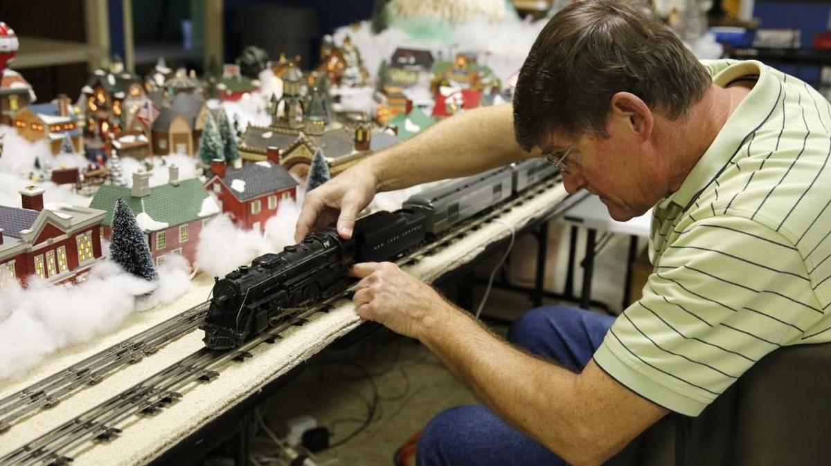The Rev. Charles Aurand of Abiding Presence Lutheran Church in York sets up his elaborate train and village collection which will be on display Monday-Dec. 30 in the church fellowship hall.