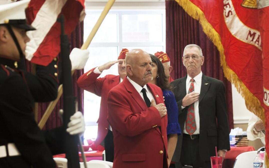 
John Wentling, center, salutes near the Marine Corps flag Saturday at the American Legion in Rock Hill. Wentling was given the title of Honorary Marine at the ceremony.
