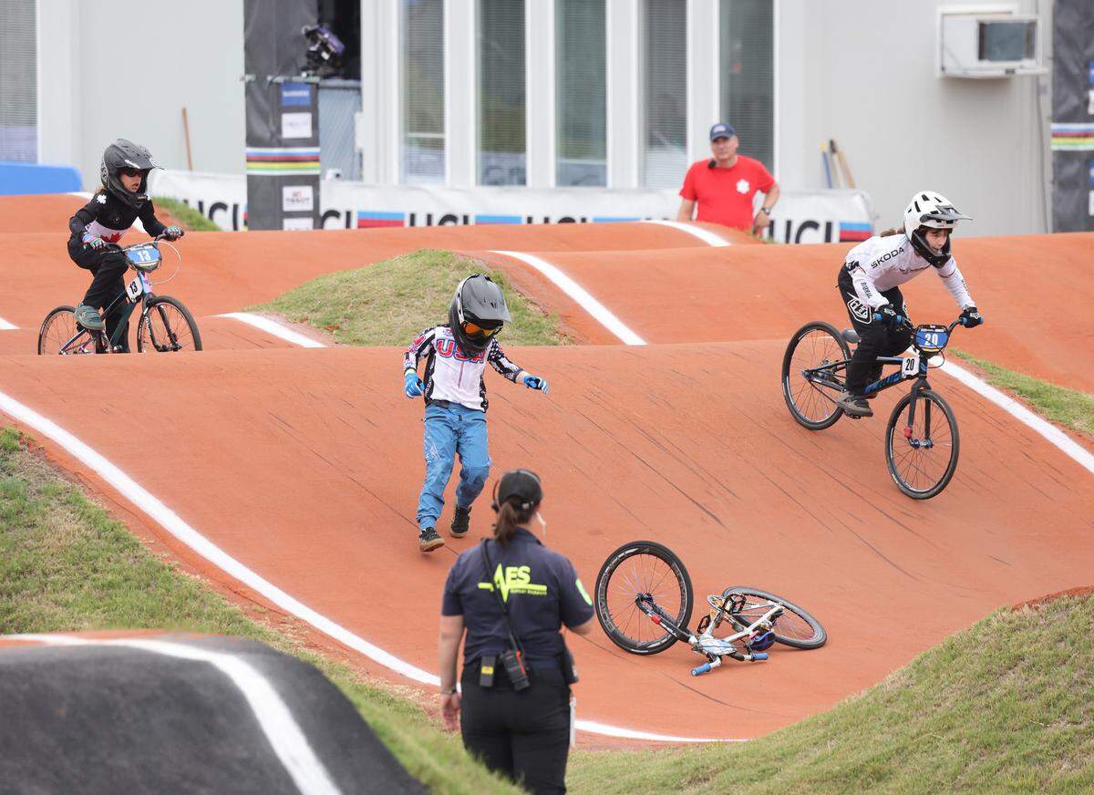 Irelyn McGinley walks to pick up her bike after falling on the track Monday at the BMX World Championships in Rock Hill.