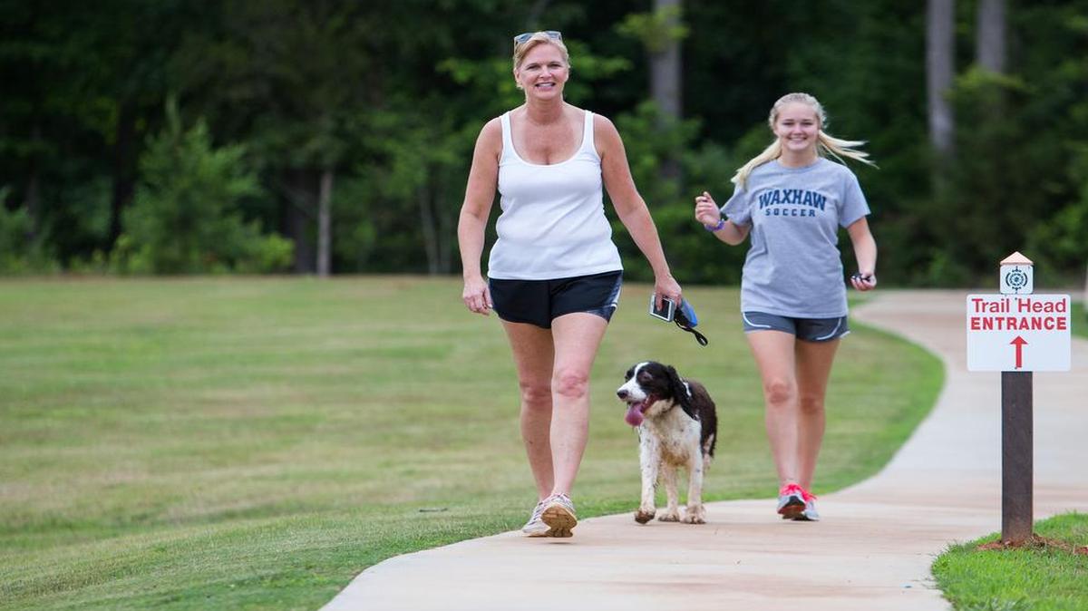 
Rebekah Thompson her dog Gatsby and her daughter CC return from the trail on Tuesday. 
