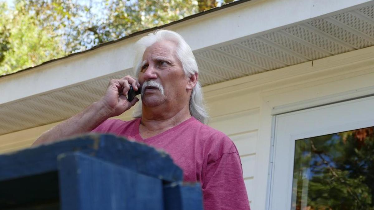 Danny Simmers speaks on the phone outside his home on the Catawba Indian Reservation. Simmers recently lost his seat on the board overseeing the Catawba Community Mental Health Center, apparently because of a 35-year-old drunken driving arrest Simmers attributes to his own mental health struggles.