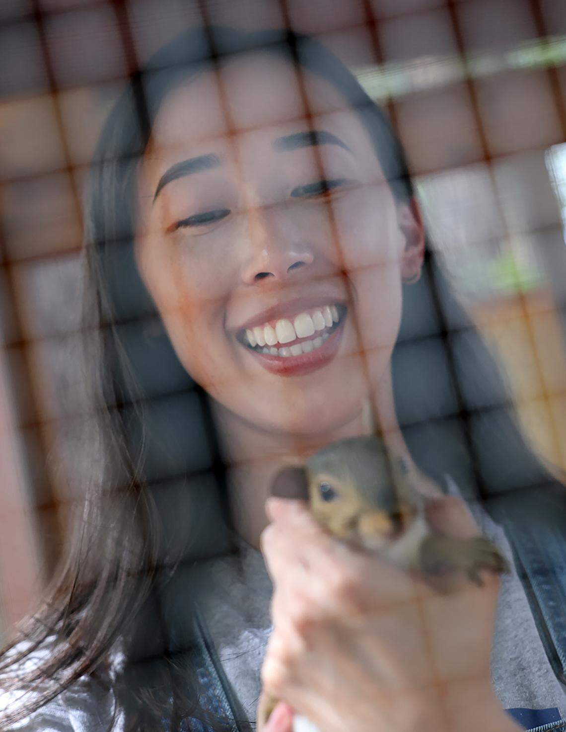 Katherine Rigby interacts with a squirrel in an enclosure at her Fort Mill home earlier this month. Rigby is a co-founder of Nutty By Nature Squirrel Rescue based in Rock Hill.