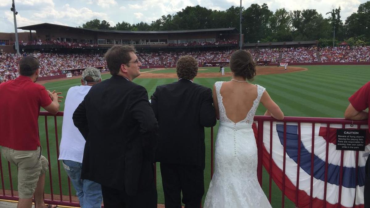 Justin and Kelsey Kata (in wedding attire) stop by Founders Park on Saturday after their wedding to take in the USC vs. Oklahoma State game