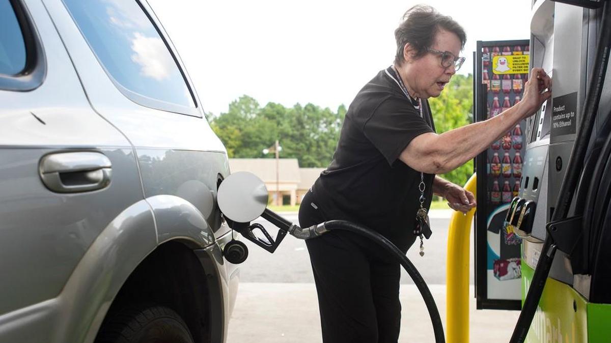 Dollie Chase inserts her card to pay for gas at a Walmart in Tyler, Texas, on Aug. 31.
