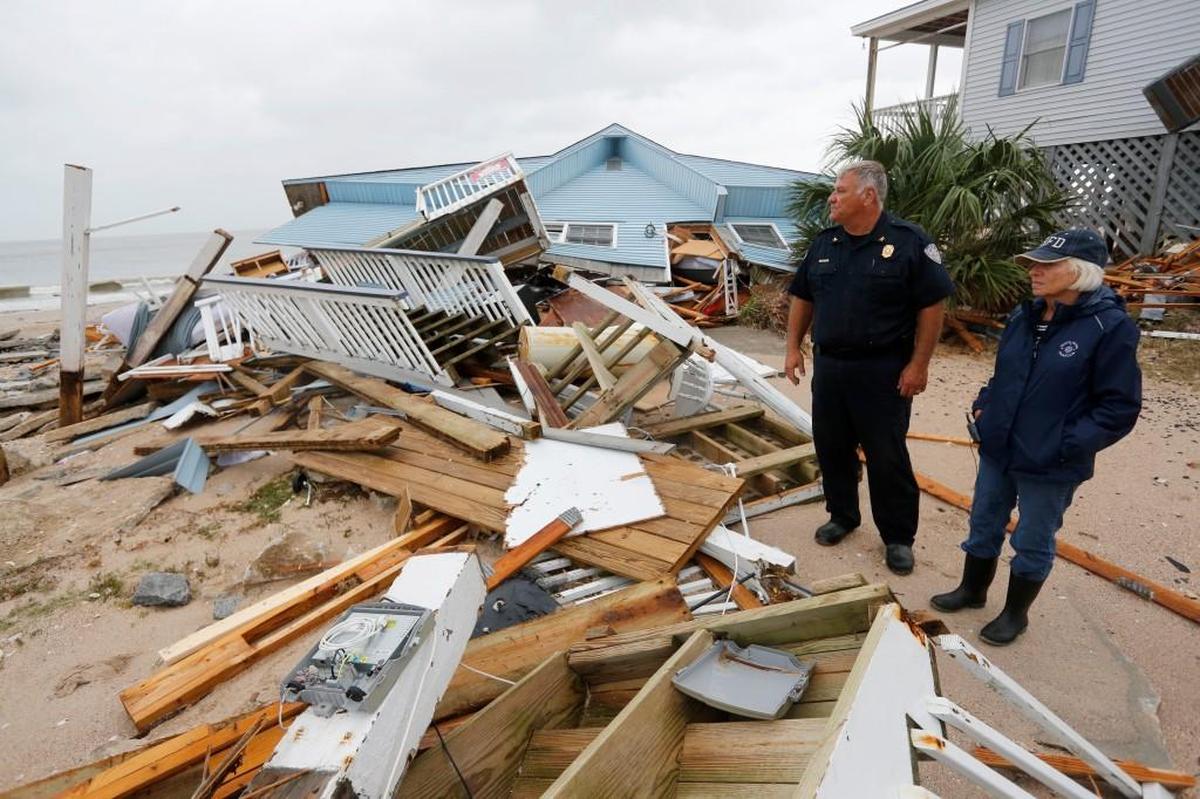 Edisto Beach’s chief of police, George Brothers, and Mayor Jane Darby survey the damage done to homes along Palmetto Boulevard after Hurricane Matthew slammed into their coastal South Carolina community Oct., 8, 2016.