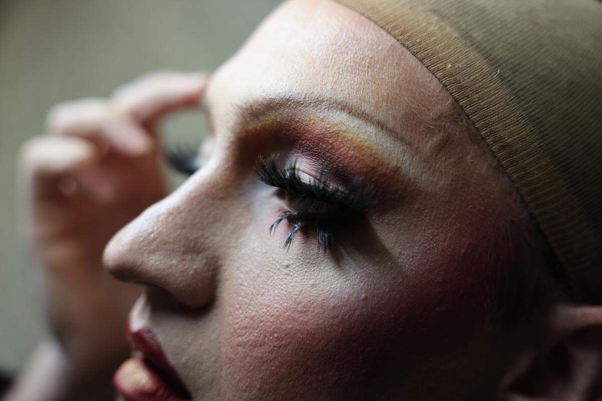 Will Lattman, known as Seveene Eleveene applies makeup before a performance at The Hideaway in Rock Hill, S.C.