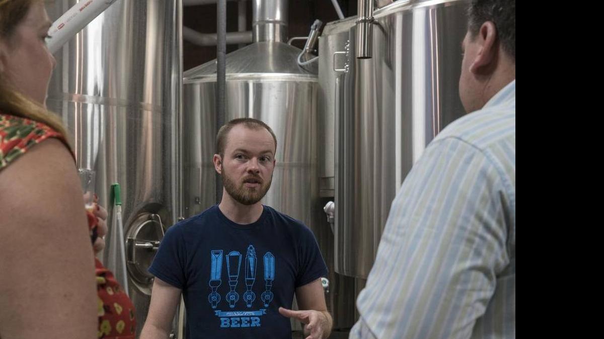
Scott Coggins benefits from the craft beer boom despite the fact that he is not a brewer. Here he leads a tour of Birdsong Brewing Co. in NoDa. His business is Charlotte Brews Cruise.
