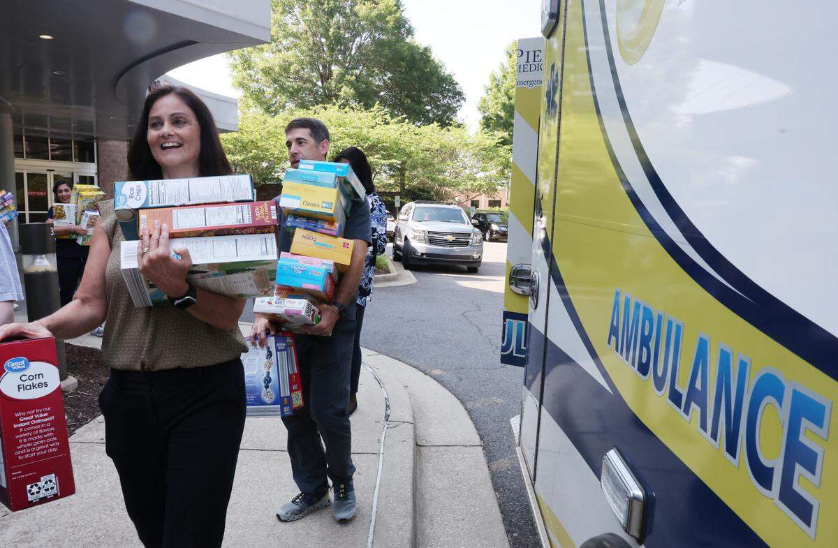Piedmont Medical Center staff, law enforcement, first responders and Pilgrim’s Inn leaders loaded an ambulance and truck Tuesday with boxes of cereal donated by the community during the Healthy Over Hungry Food Drive in Rock Hill.