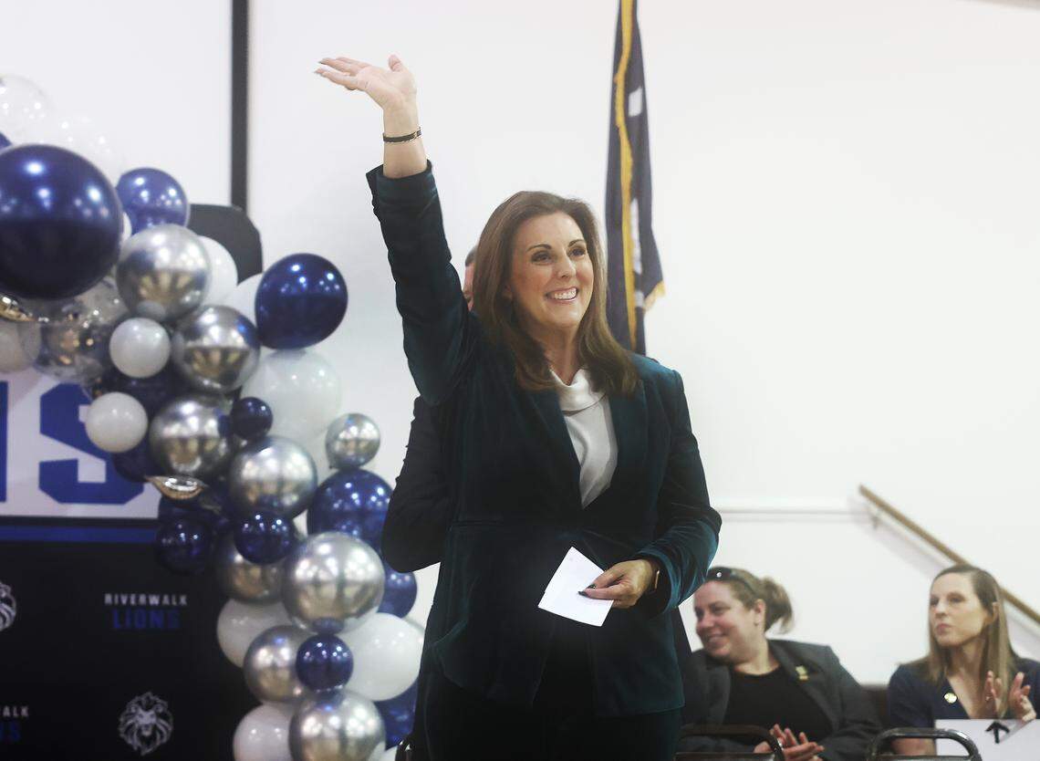 South Carolina Superintendent of Education Ellen Weaver waves at a crowd before speaking at an assembly for Riverwalk Academy in Rock Hill. A principal there won a Milken Educator Award Tuesday.