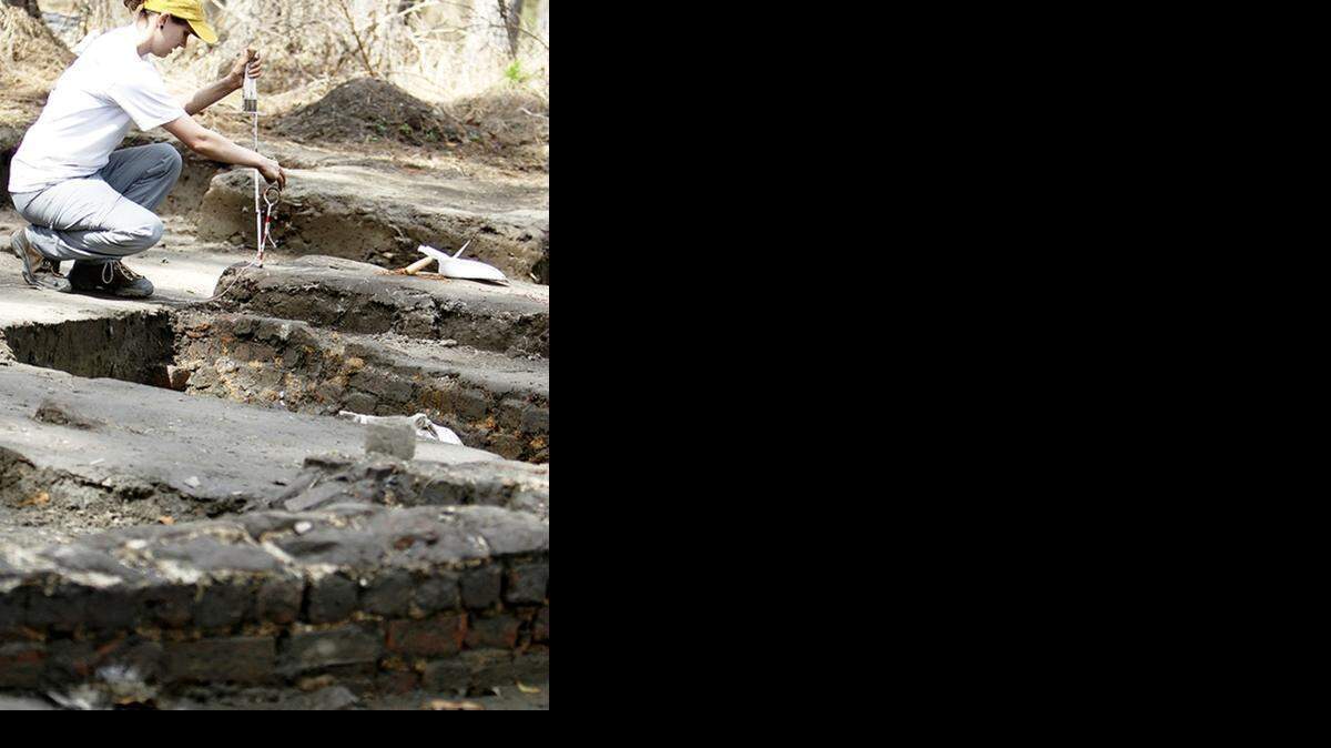 
Sarah Stephens measures a feature in the soil of a slave house at Hampton Plantation in Georgetown County on Wednesday.
