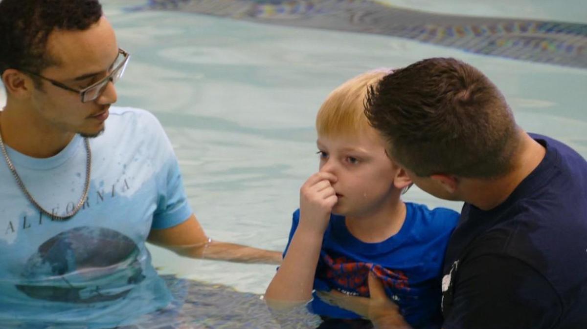 Austin Pannell plugs his nose as he prepares to be baptized by his father, Pastor Jonathan Pannell of Rock Hill’s Emmanuel Church of the Nazarene. The younger Pannell was one of 16 to be baptized at the Rock Hill Aquatics Center on Sunday.