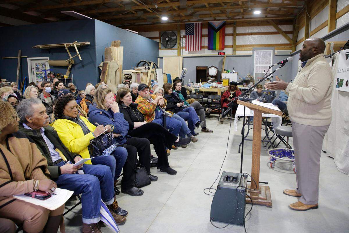 John Smith, a board member for Nation Ford Land Trust and UNC Charlotte faculty member, right, talks about funeral traditions for enslaved people Saturday at The 144: Honoring the Lost Ancestors ceremony and fundraiser for the Nation Ford Land Trust.