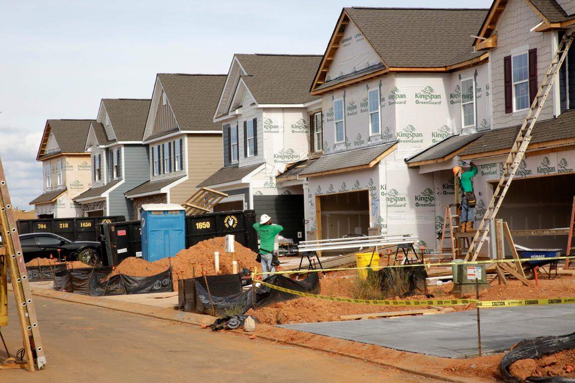 A construction crew works on new houses in Fort Mill on Monday. The Elizabeth subdivision is the latest large project to grow the town’s population, after building at Springfield, Massey and Waterside at the Catawba and others.