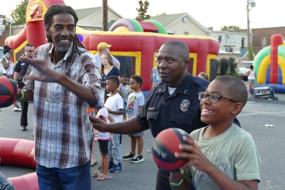 Herald file: Chanse Hamilton, right, gets coaching from York Police Officer Pierre King to beat his grandfather Steve Love at a game of hoops at York’s celebration of “National Night Out” in 2015. National Night Out is a nationwide campaign that seeks to improve police-community relations while also providing information to residents to make neighborhoods safer.