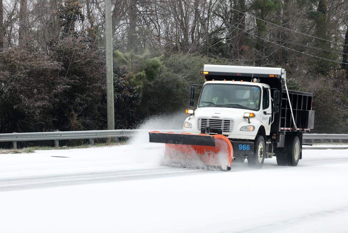 A plow scrapes India Hook Road in Rock Hill, S.C. mid-day on Sunday, Jan. 25, 2026. Forecasters predict heavy snow this weekend throughout the Rock Hill region.