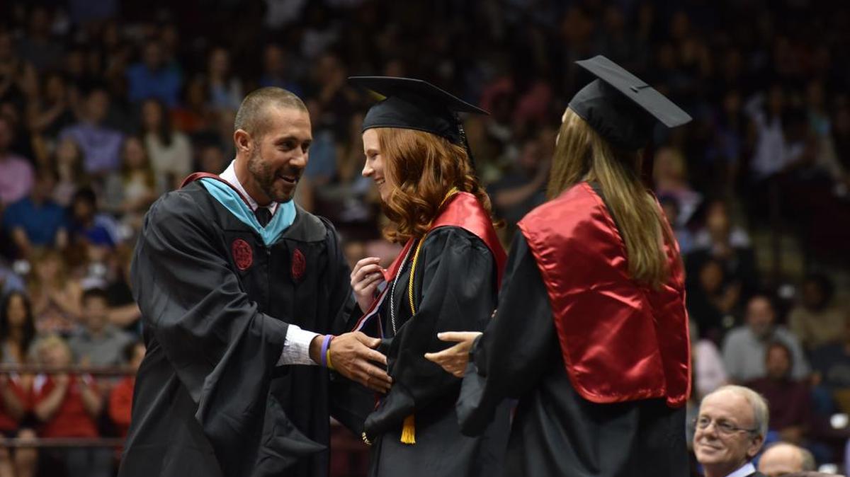 Nation Ford principal Jason Johns recognizes salutatorian Baillie Ruth Steele, center, and valedictorian Jordan Davis Sawyer, right, Saturday during commencement exercises at the Winthrop Coliseum.
