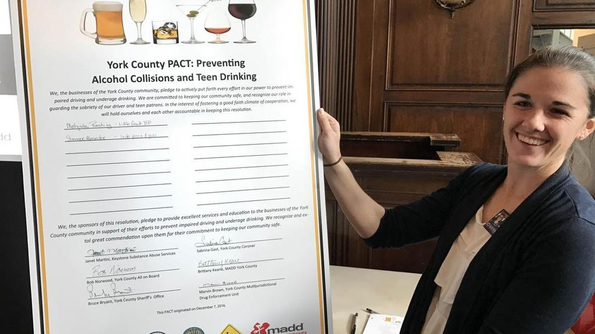 Keystone Substance Abuse Services representative Danielle Center holds the 2016 York County PACT, which mandates employees of restaurants be cautious about alcohol.