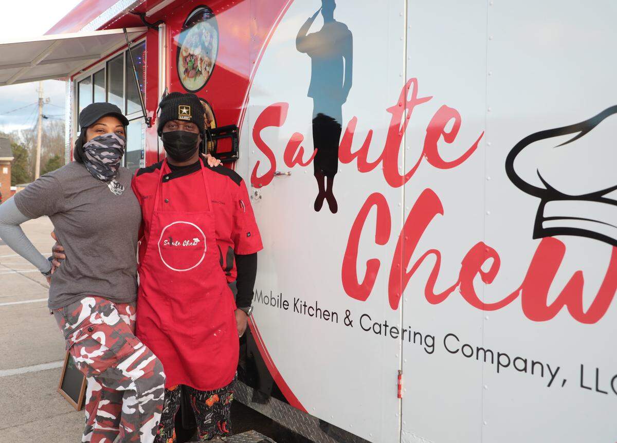 Ceslie and Tyrone Jenkins of Rock Hill stand outside their food truck, Salute Chew.
