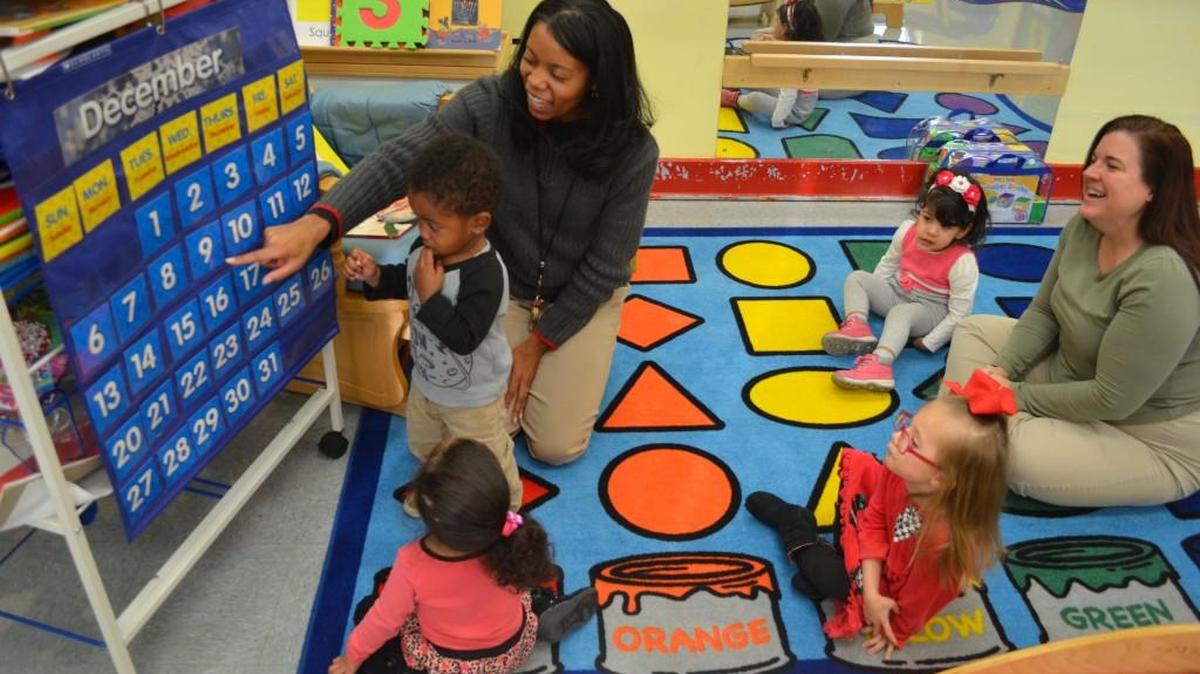 Chuana Morgan teacher her class of two-year-olds about the calendar at the Rock Hill Family Resource Center with the help of Krystal Morgan. Her students are Itzel, Sophia, Yaretzy and Trayon.