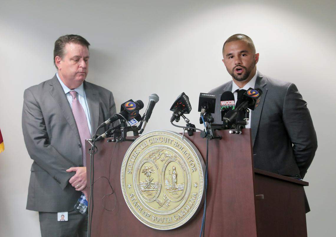 Former Rock Hill police officer John Moreno, right, apologizes to Travis Price during a press conference Thursday at Moss Justice Center as Sixteenth Circuit Solicitor Kevin Brackett stands by.