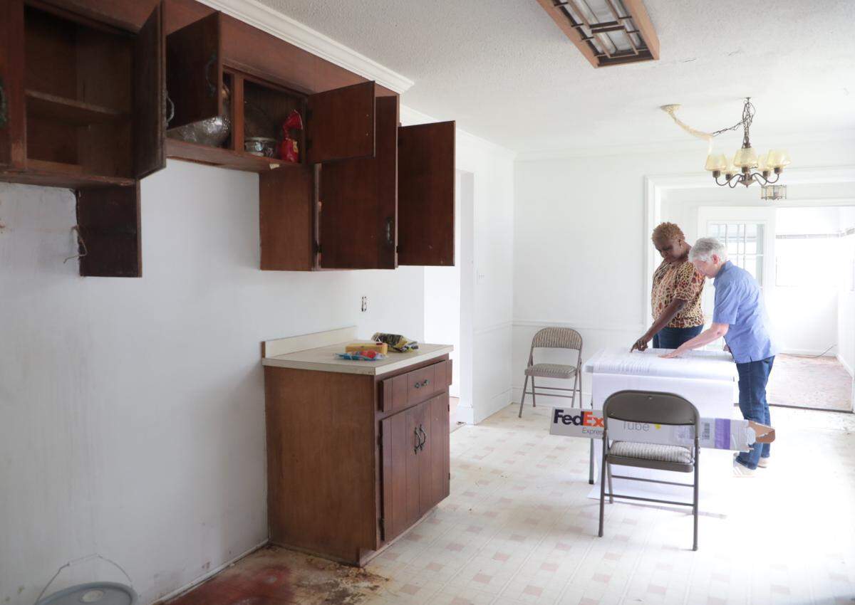 Regeana Phillips, left, and Sue Fullteron look over blueprints of the future Her Place women’s homeless shelter Thursday in Rock Hill