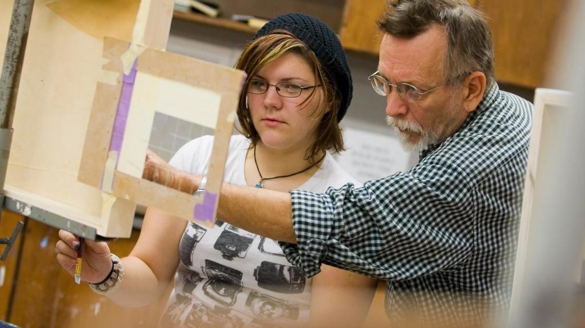 Paul Martyka, right, associate professor of fine arts at Winthrop University, works with a student.