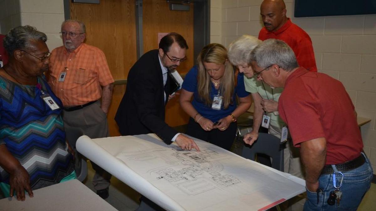 
James Wilhide, an architect and registered educational facilities planner for Moseley Architects of Charlotte, points out changes that could be made at South Pointe to school board members Helena Miller, Jane Sharp and Terry Hutchinson and South Pointe Athletic Director Michael Drummong (in back). The school board toured the three high schools Friday as it studies equity among the schools. 
