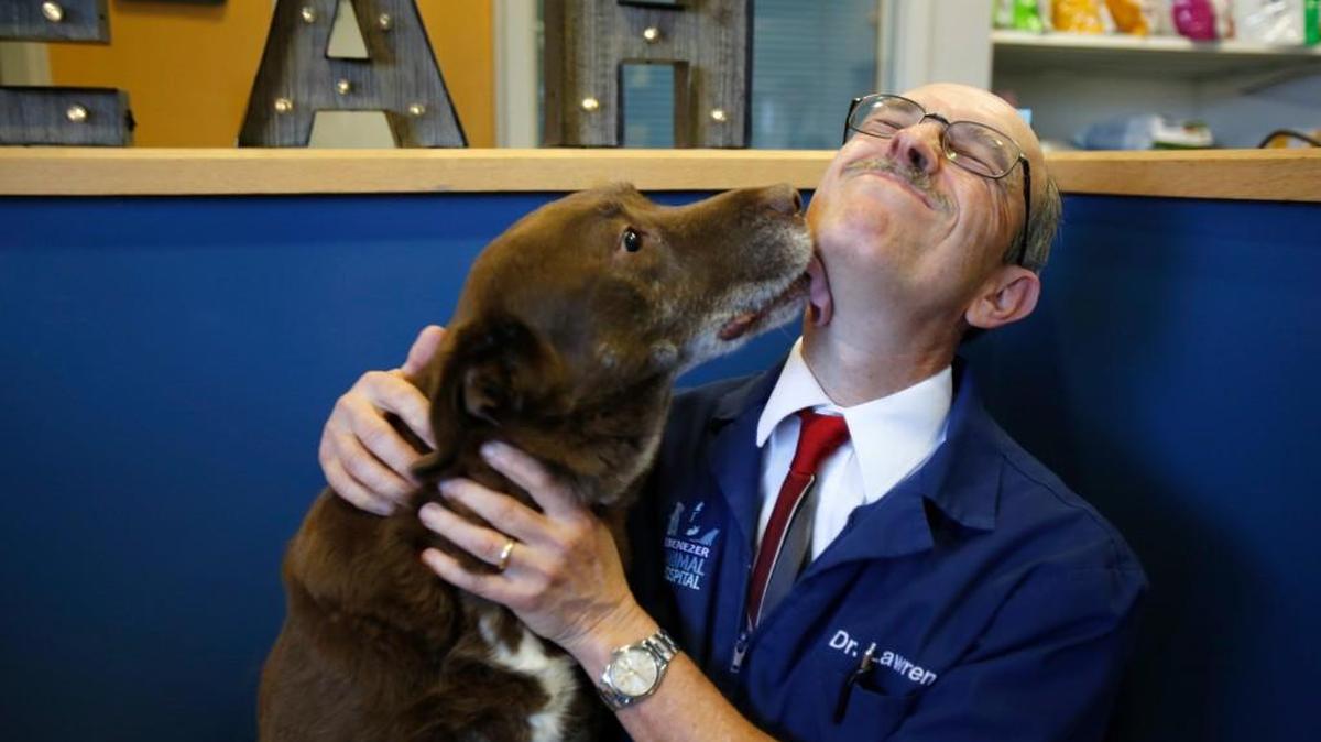 
Dr. Lorin Lawrence at Ebenezer Animal Hospital retired Wednesday after 30 years. Lawrence gets a kiss from Charlie.
