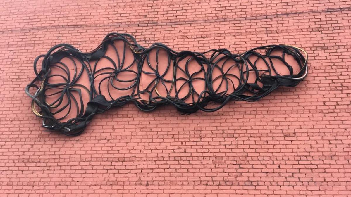 “Tread” a sculpture by Leah Cabinum is on the exterior wall at Swim, Bike & Run on East White Street in Rock Hill.
