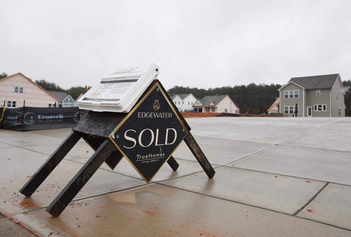 A sold sign sits in the driveway of a future home in Edgewater in Lancaster County. Lancaster County homes are selling at a higher median price point than home across the Charlotte region are.