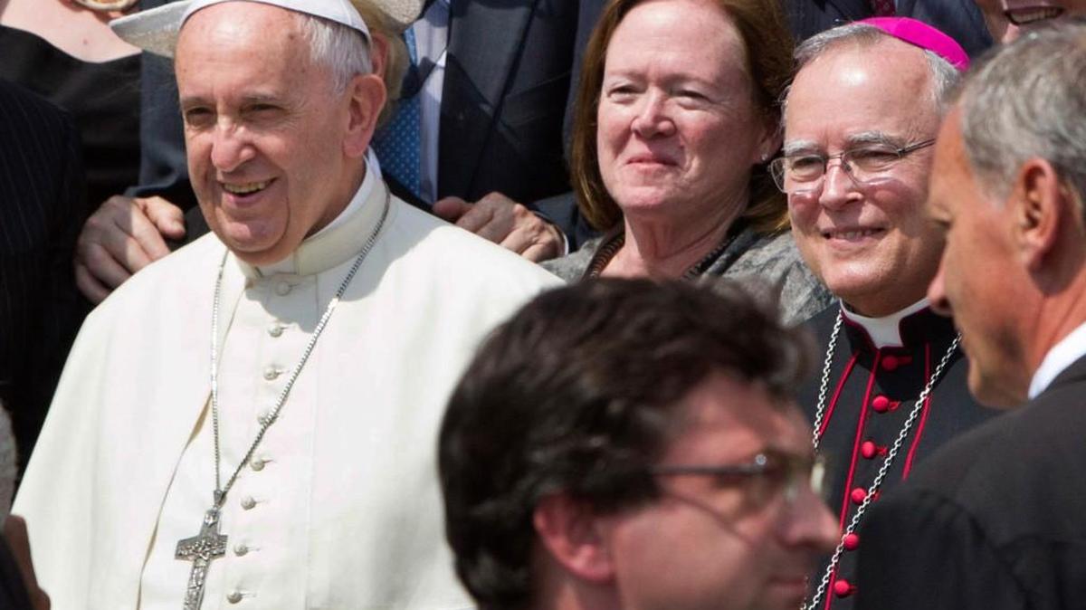 
Philadelphia’s Archbishop Charles Chaput, right, stands next to Pope Francis as they pose for a photo with a delegation from Philadelphia at the end of the pontiff’s weekly general audience in St. Peter’s Square at the Vatican in June. Pope Francis will be traveling to Philadelphia in September to attend the World Meeting of Families. Chaput, the meeting’s host, is moving to limit lesbian, gay, bisexual and transgender Roman Catholics as they try to lobby for a broader role in the event. 
