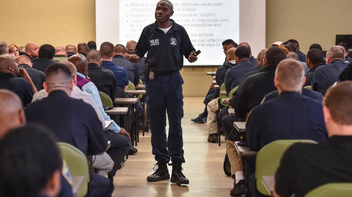 Officer Edward Gillespie, of the Baltimore Police Department’s education and training division, teaches a session on fairness, impartiality and implicit bias. Gillespie asks the officers to consider what they are observing and to be aware that their biases – for better or worse – will often fill in blanks.