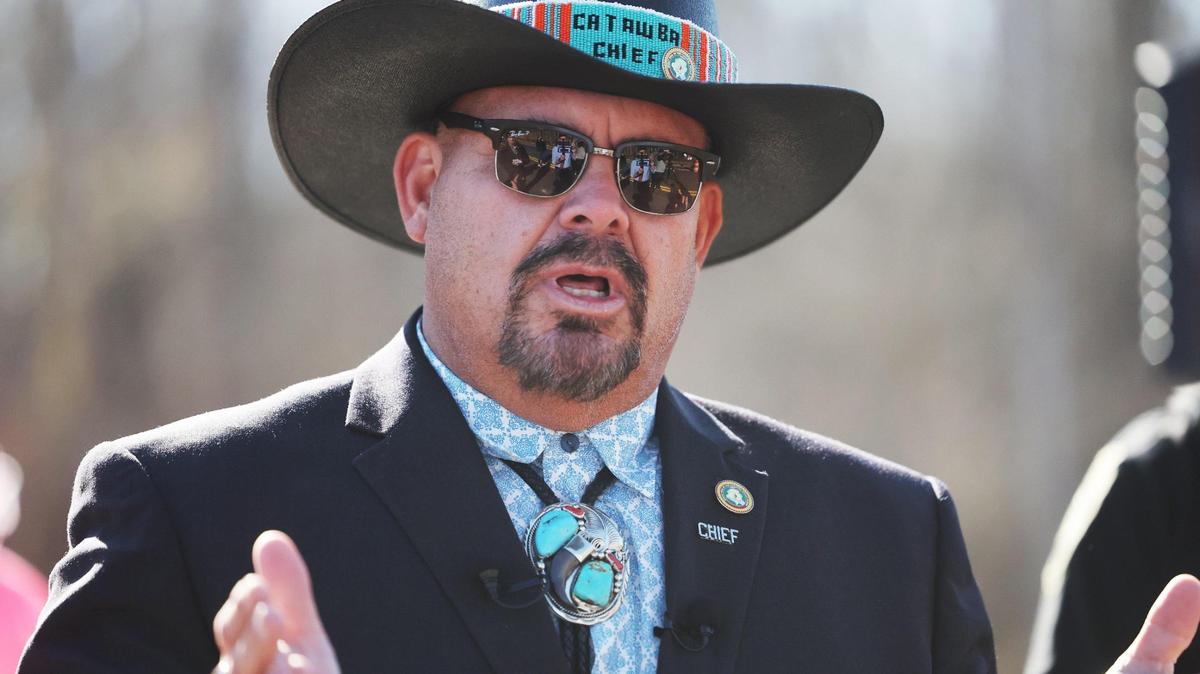 Catawba Indian Chief Brian Harris talks to a group of residents gathered at a new bridge Wednesday near the intersection of Sturgis Road and Rivercrest Road. The residents gathered for an official ribbon-cutting ceremony.