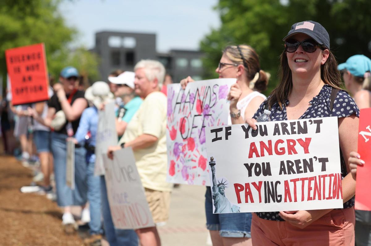 Demonstrators with York County Rising protest President Trump and his policies Sautrday in downtown Rock Hill.