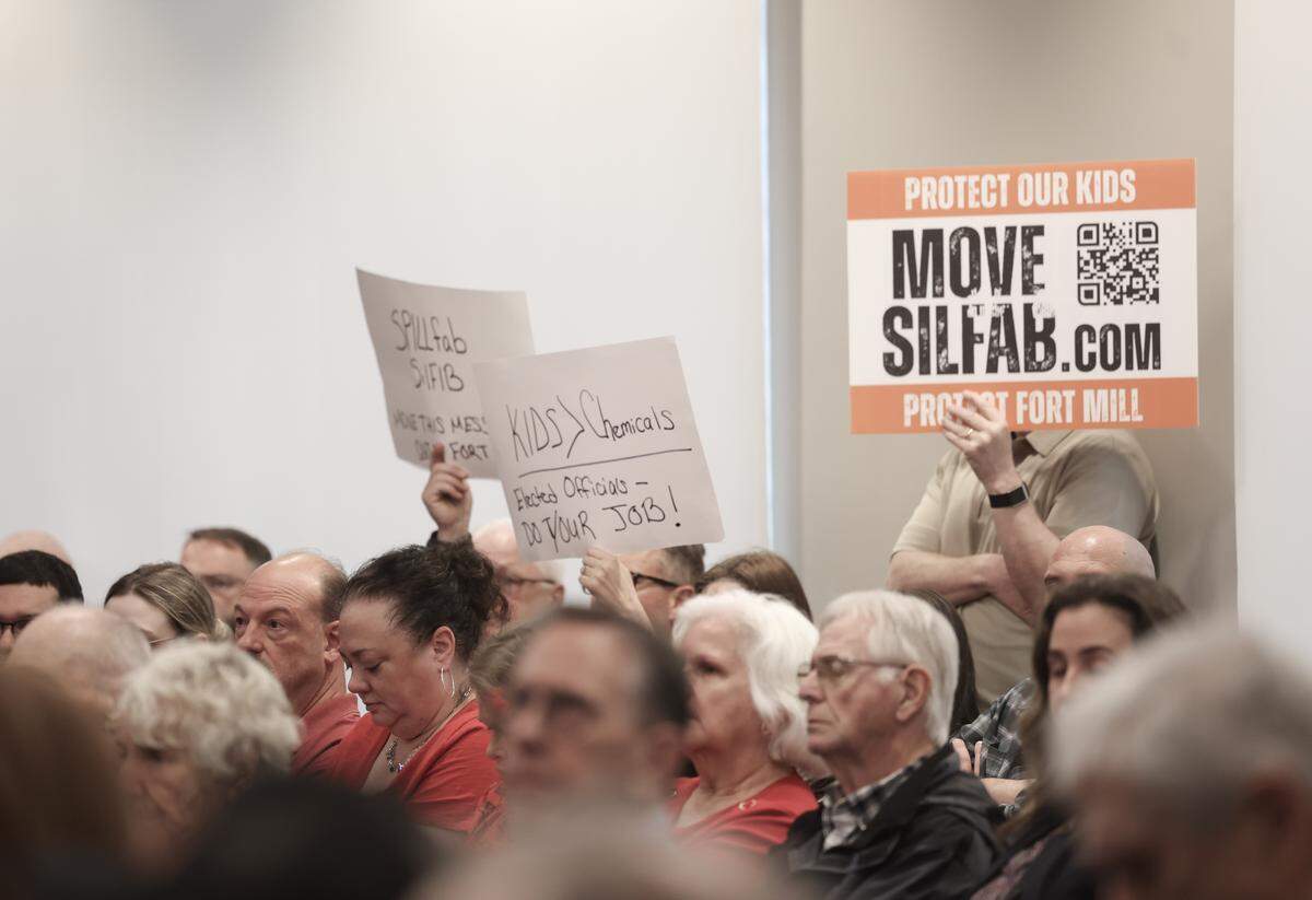 Protesters hold signs at the York County Council meeting Monday, March 16, 2026 to pursuade the council to revoke Silfab Solar's certificate of occupancy.