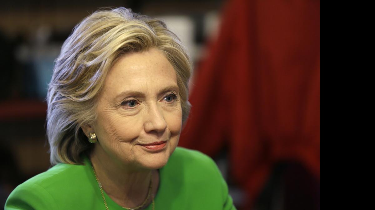 
In this April 14, photo, Democratic presidential candidate Hillary Rodham Clinton meets with local residents at the Jones St. Java House in LeClaire, Iowa.
