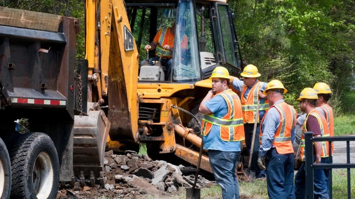 A SCDOT crew digs up asphalt on Pole Branch Road near the North Carolina-South Carolina border on Thursday.