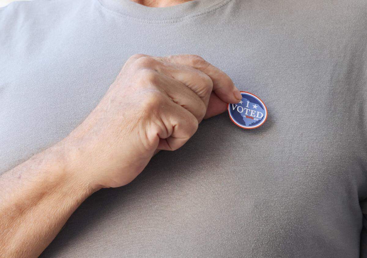 A voter puts on an “I voted” sticker Tuesday at Tega Cay Baptist Church.