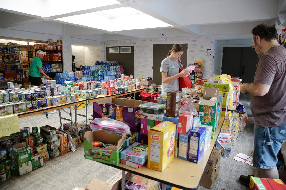 Volunteers at Black Mountain Presbyterian Church sort through groceries on Friday, Oct. 4, 2024