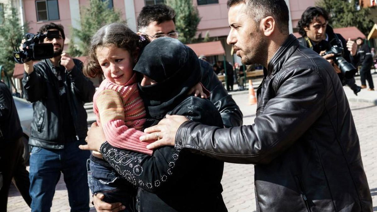 A Turkish man helps a Syrian woman carrying a wounded Syrian girl to a hospital in Kilis, Turkey, this week. The fighting in northern Syria has huge implications in the civil war and risks erupting into a wider regional conflict. The battle for control of Aleppo involves all the major players over a prized strip of rebel-held territory near the Turkish border.
