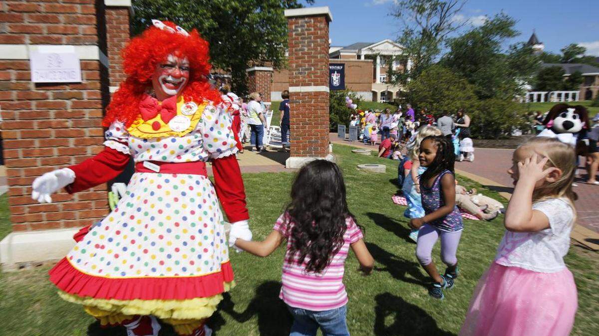 
The Come-See-Me Teddy Bear Tea Party was held Tuesday on the Winthrop University College Green. Noodle (Julie Byrum with the Carolina Clowns) dances with children at the Teddy Bear picnic.
