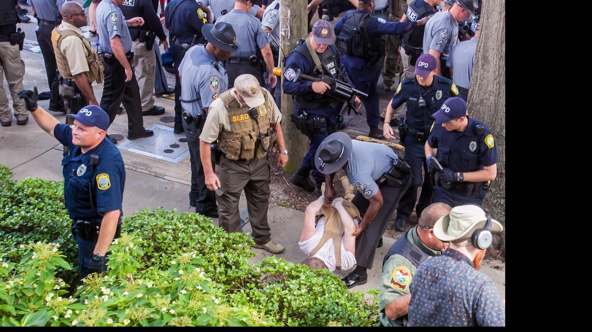 
Law enforcement make an arrest following a KKK rally at the State House in Columbia, SC.
