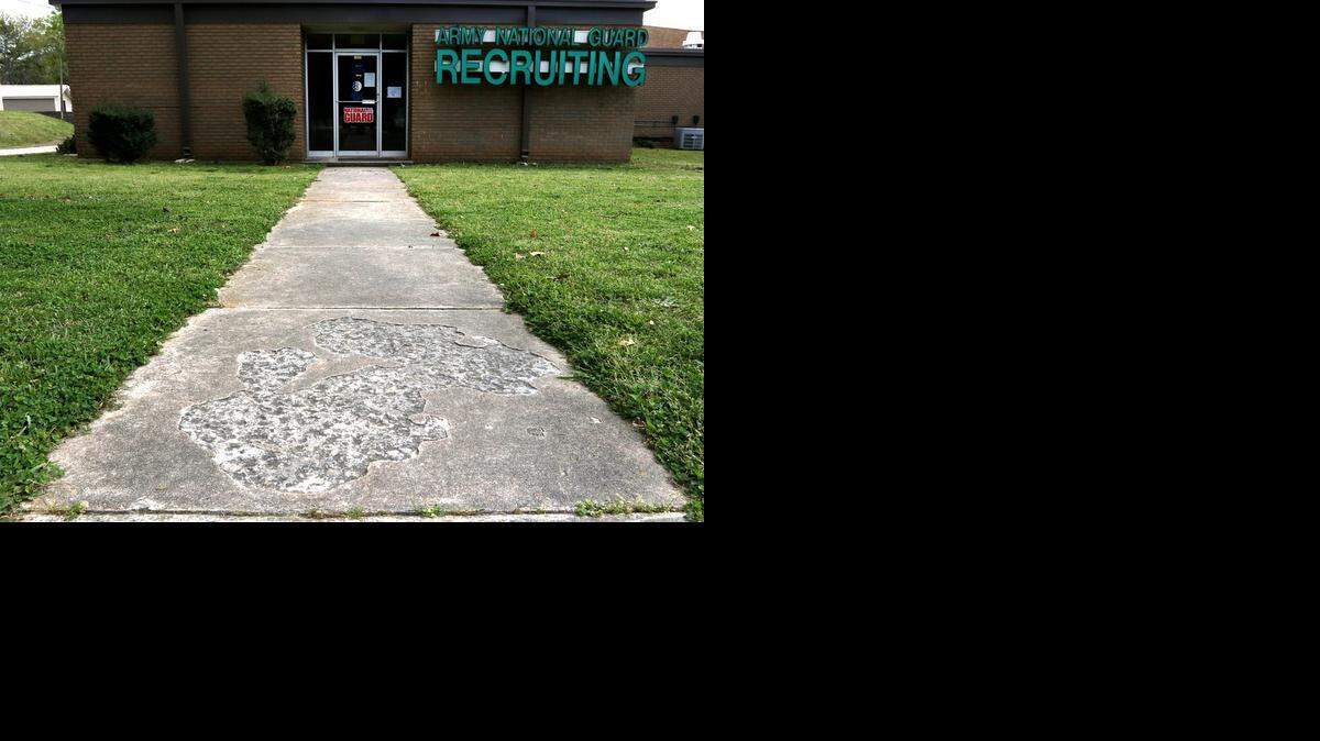 
Crumbling sidewalks lead to the entrance of the National Guard Armory in Greenwood, S.C. “Young people come with their parents, and I would think they question whether they want to let their young kids join an organization that maintains their facilities in this state,“ Maj Marty Hanks said of the National Guard Armory and Recruiting Office in Greenwood. 
