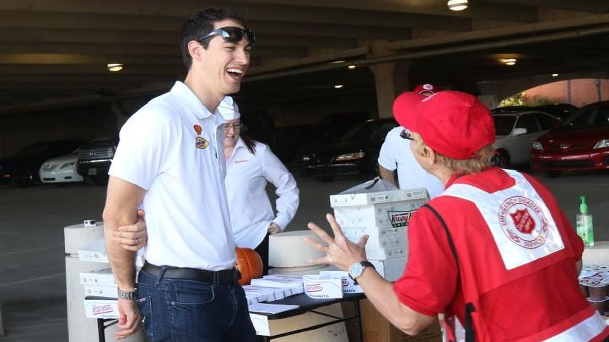 
NASCAR driver Joey Logano jokes with Red Cross volunteer Michele Wells on a stop at the South Carolina State Museum Thursday Columbia to see the flood damage firsthand. 
